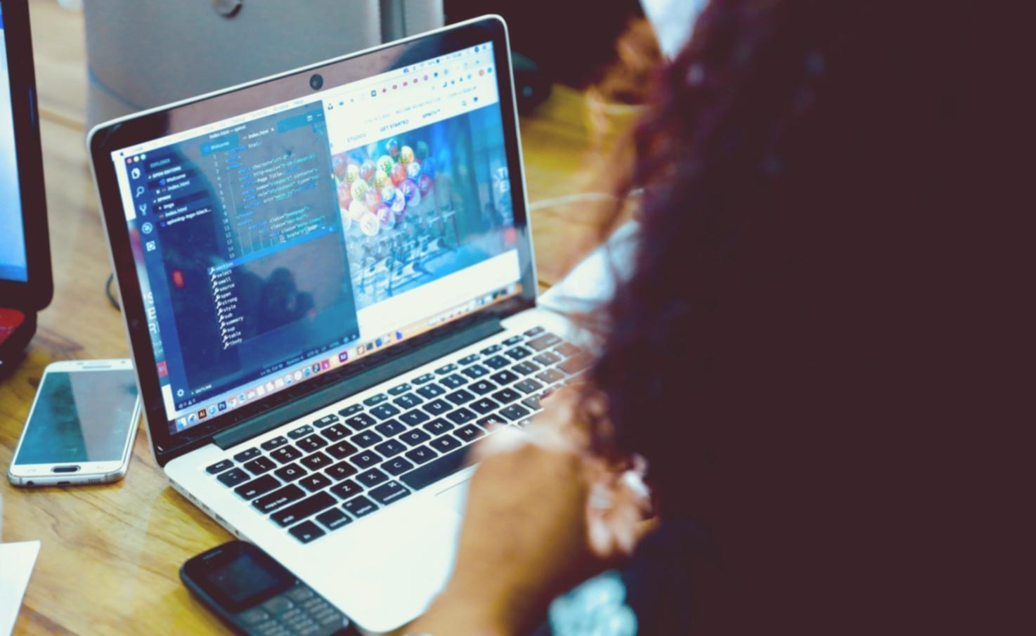 Close-up view of blockchain code implementation on computer screen with network visualization tools